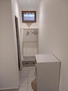 a kitchen with a white refrigerator and a window at Le Lohan in Port-Saint-Louis-du-Rhône