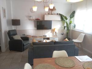 a living room with a couch and chairs and a tv at Apartamento limonero ,VUT AL 13044 in Albox
