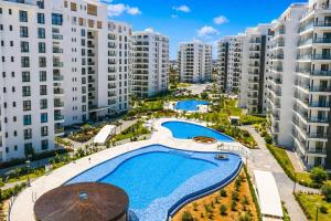 an aerial view of an apartment complex with a swimming pool at Caesar Blue Collection Nothern Cyprus Studios & Spa Resort in Kaimakli