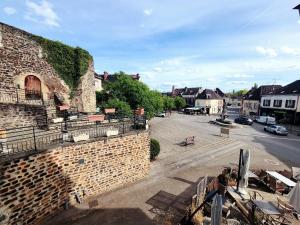 an old brick building with a street in a town at Cœur de Toucy in Toucy