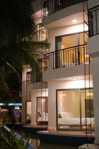 a building with a bed in the middle of it at Cham Riverside in Thôn Xuân Lạc
