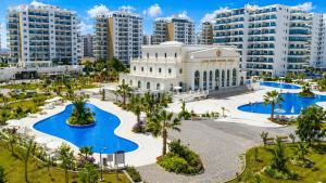 a building in a city with tall buildings at Nothern Cyprus Caesar Resort & Spa Collection Pools & Long Beach in Aglantzia