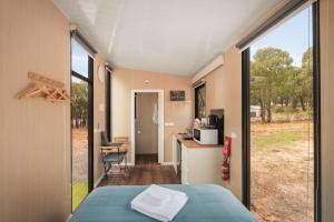 a room with a bed and a large window at Kiara By Tiny Away in Stawell