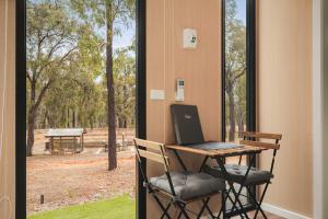 a desk with a laptop on it next to a window at Kiara By Tiny Away in Stawell +15 photos