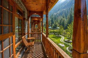 a balcony of a cabin with a view of a garden at 8fold by Larisa, Jibhi in Jibhi
