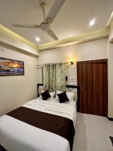 a bedroom with a large bed with white sheets at Hotel The Galaxy in Dabok +16 photos