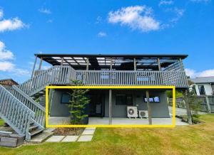 a house with a deck and a staircase at Serene Star in Lake Tekapo