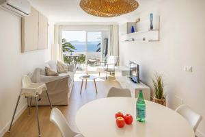 a living room with a white table and chairs at Apartment Vida Sana by Sealand Villas in Alcudia