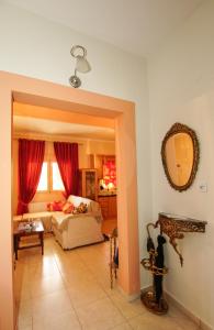 a living room with a bed and a mirror at Myrtus House in Kato Loutraki