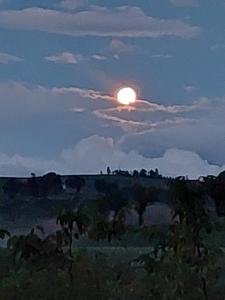 a sunset with the sun on top of a hill at Orchard House North in Pergola