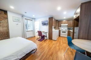 a bedroom with a bed and a table and chairs at Near the Ferry - Studio de charme in Lévis