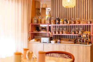 a room with a table and a shelf with jars at Nice Centre Hotel in Nice