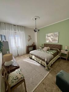 a bedroom with a bed and a chandelier at La Casettina della Cantina in Prasco