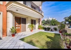 a courtyard of a house with a lawn at Royal Residence Golf Course Road in Gurgaon