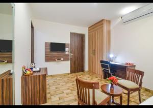a living room with a table and a dining room at Royal Residence Golf Course Road in Gurgaon