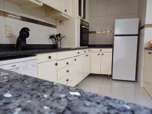 a kitchen with white appliances and a white refrigerator at San Jose Luminoso in Algemesí +22 photos