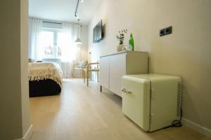 a living room with a refrigerator and a bedroom at Boutique Hotel an der Mosel - ehemalig Hotel Kreuter in Koblenz
