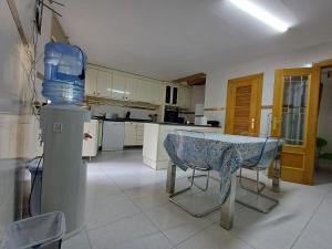 a kitchen with a table and a bottle of water at San Jose Luminoso in Algemesí