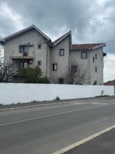 a large white building on the side of a road at Vila Ardealul in Mangalia