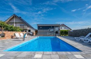a swimming pool in the backyard of a house at Villa Cis in Darłowo