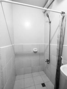 a bathroom with a shower and a sink at Zefe's Hideout in Lapu Lapu City +6 photos