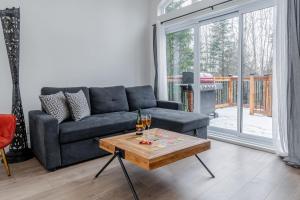 a living room with a couch and a coffee table at Pool Spa sauna & Pool Table - Beaulieu 110 in Pont-Rouge +38 photos