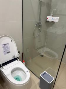 a bathroom with a toilet and a glass shower at D02 - Happy Beach Villas - No2 Căn hộ Z&Z Triple key - NovaWorld Ho tram in Binh Chau +22 photos