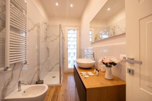 a bathroom with a sink and a toilet and a shower at Il fienile del borgo in Prato