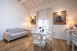 a living room with a table and a couch at Il fienile del borgo in Prato +40 photos