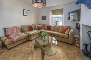 a living room with a couch and a glass table at 2 Bed in Warkworth oc-coq95 in Warkworth