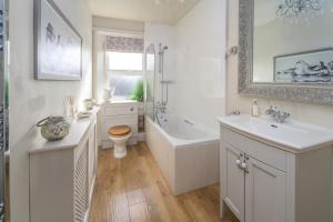 a bathroom with a tub and a toilet and a sink at 2 Bed in Warkworth oc-coq95 in Warkworth +10 photos