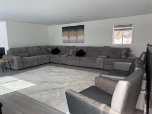 a living room with a couch and a table at View Spa and St-Lawrence River - The DG Chalet in Sainte-Petronille +41 photos
