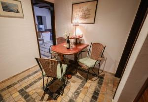a small table with chairs and a lamp on it at Apartment Stern in Perast