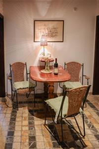 a table and chairs with a bottle of wine on it at Apartment Stern in Perast