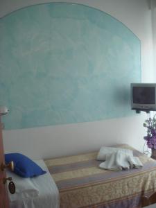 Uma cama ou camas num quarto em Hotel Arcade