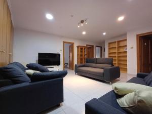 a living room with two couches and a tv at San Jose Luminoso in Algemesí