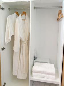 a closet with white towels on a rack at Ther lay beach resort in Sikao +22 photos