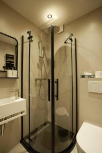 a bathroom with a shower with a toilet and a sink at Boutique Hotel an der Mosel - ehemalig Hotel Kreuter in Koblenz +197 photos