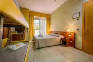 a hotel room with a bed and a window at Hotel Remin Plaza in Rimini +31 photos