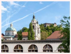 a large building with a clock tower in the background at The 1826 Residence in Ljubljana