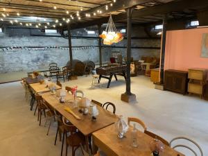 a room with wooden tables and chairs and a piano at Le Studio 3 - Route des vins in Rorschwihr