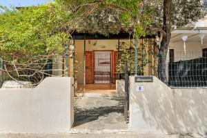a front door of a house with a fence at Casa Gianpiero San Teodoro in San Teodoro