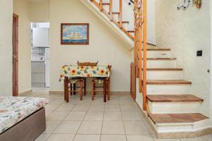 a kitchen with a table and stairs in a room at Casa Gianpiero San Teodoro in San Teodoro