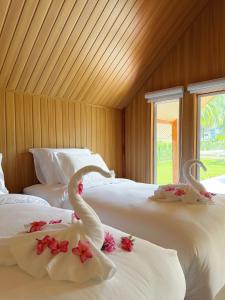 a bedroom with two beds with swans on them at Ther lay beach resort in Sikao