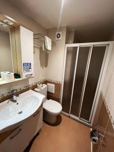 a bathroom with a white sink and a toilet at Le Safran Palace in Istanbul +37 photos
