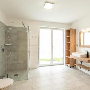a bathroom with a shower and a sink at Luxalps- BergZeit- Inzell- Sommerpool- Sauna- Wandern- Chiemgau Card in Inzell