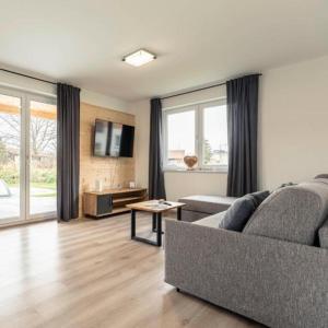 a living room with a couch and a table at Luxalps- BergZeit- Inzell- Sommerpool- Sauna- Wandern- Chiemgau Card in Inzell +15 photos