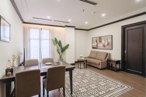 a living room with a dining table and a couch at CityHouse - Atelier Thảo Điền in Ho Chi Minh City