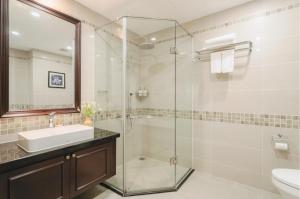 a bathroom with a glass shower and a sink at CityHouse - Atelier Thảo Điền in Ho Chi Minh City +49 photos