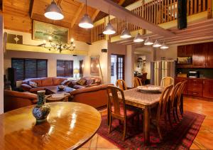 a kitchen and living room with a table and chairs at Waterkloof Apartments in Pretoria